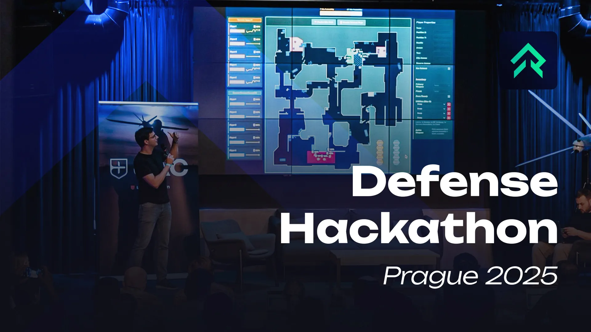 Rankacy engineer presenting a Counter-Strike map analysis on a large screen at the Defense Hackathon Prague 2025, with the event title overlaid.