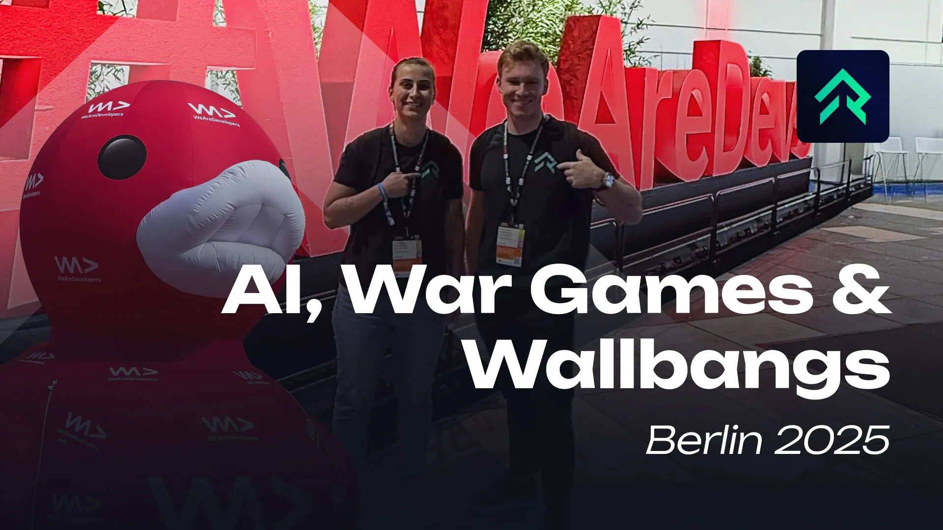 Two Rankacy team members in front of the red WeAreDevelopers letters in Berlin, with the title “AI, War Games & Wallbangs” overlaid.